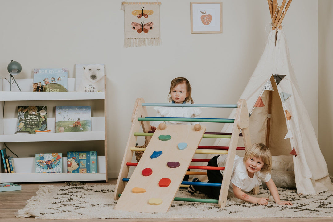 Toddler Climbing On A Pikler Triangle