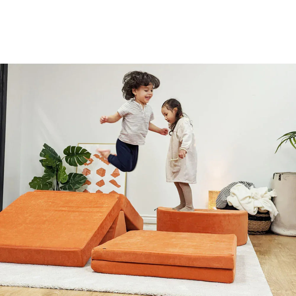 Kids jumping and playing with a orange play couch made in Canada
