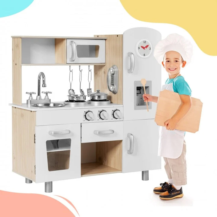 Children's play kitchen set with a child in chef attire holding a cardboard box.
