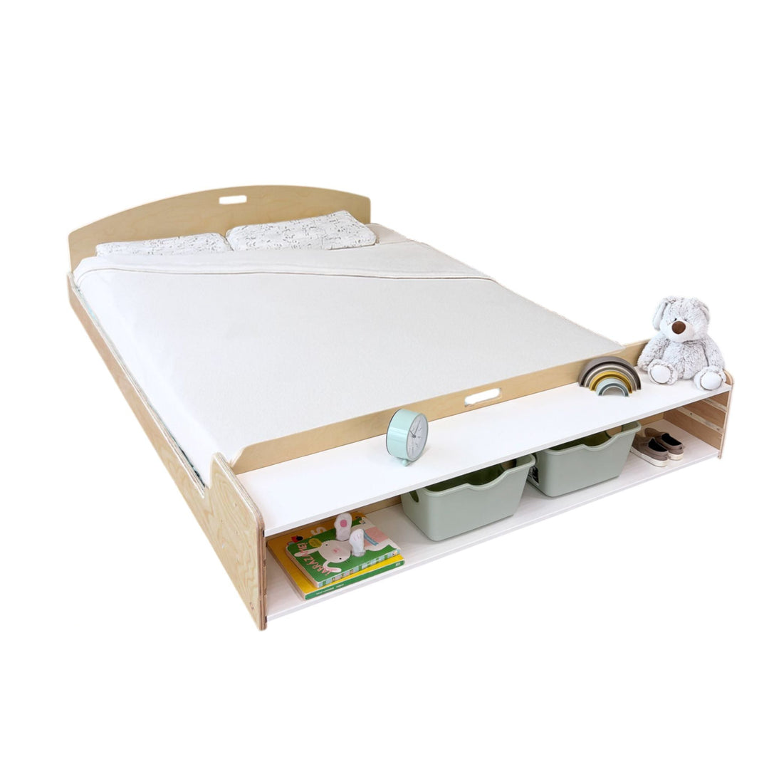 Wooden bed with mattress and storage drawers on a white background