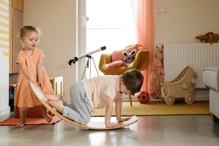 Children Playing With A Wooden Wobble Board
