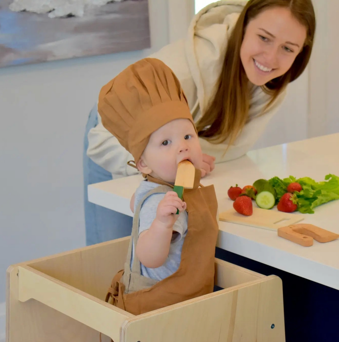 Toddler helping cooking with the mother