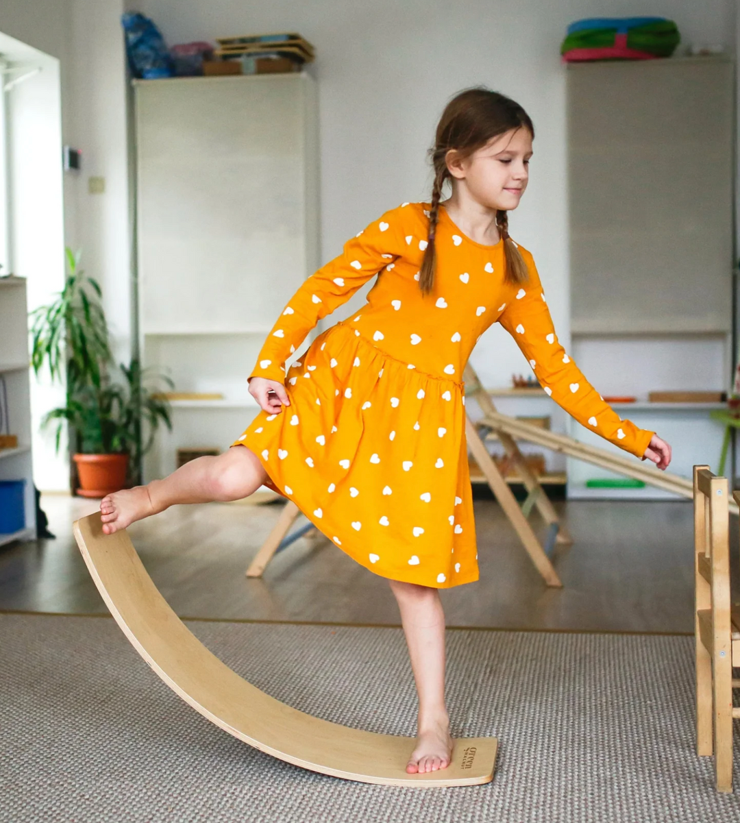 Girl Balancing On A Balance Wobble Board