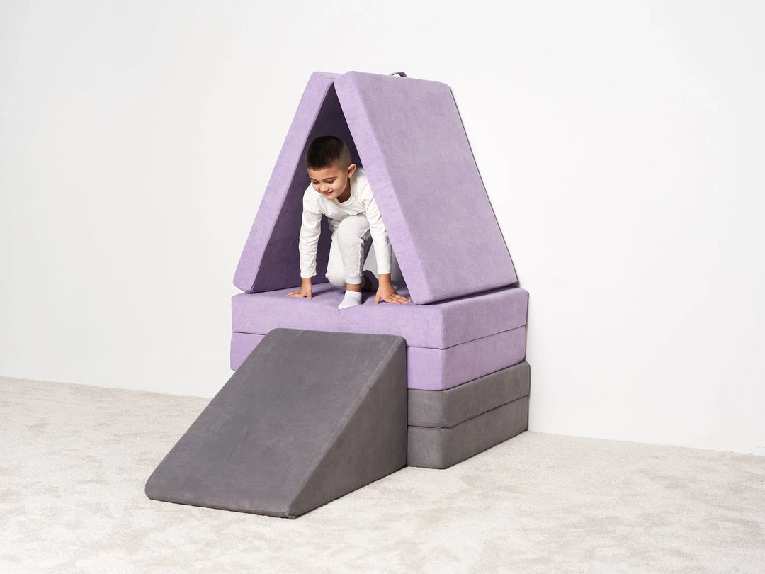 Kid playing with purple and grey play couch