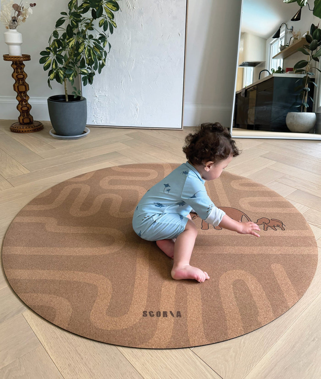 baby playing on a round yoga cork mat