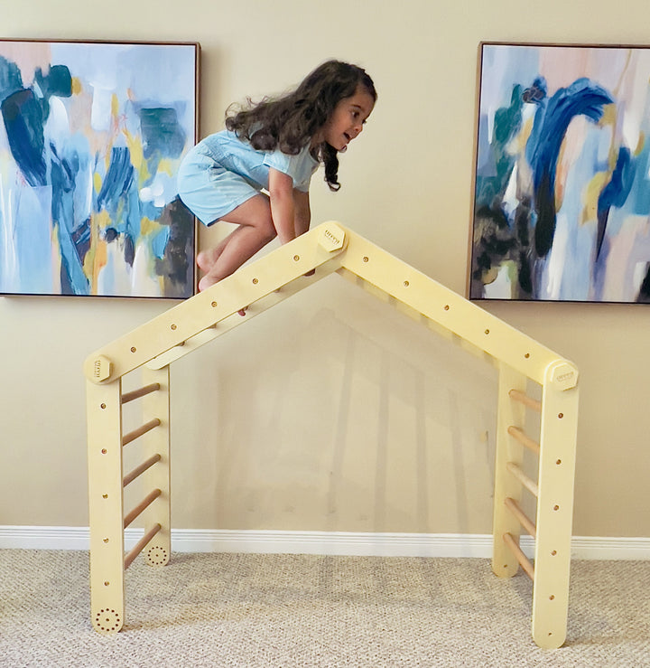 Kid Climbing On A Wooden Pikler Triangle