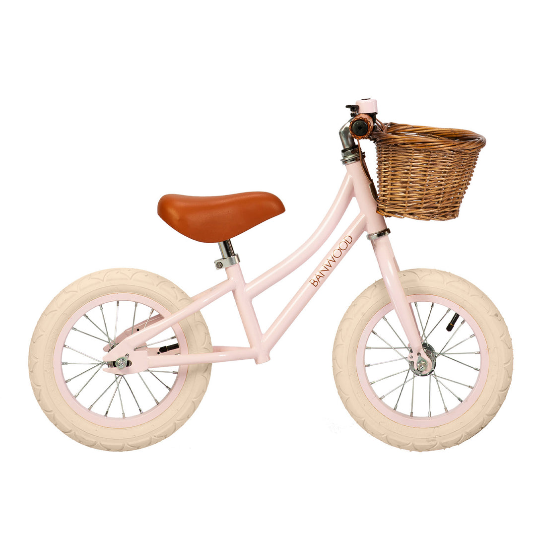 Banwood First Go balance bike in Pink with wicker basket
