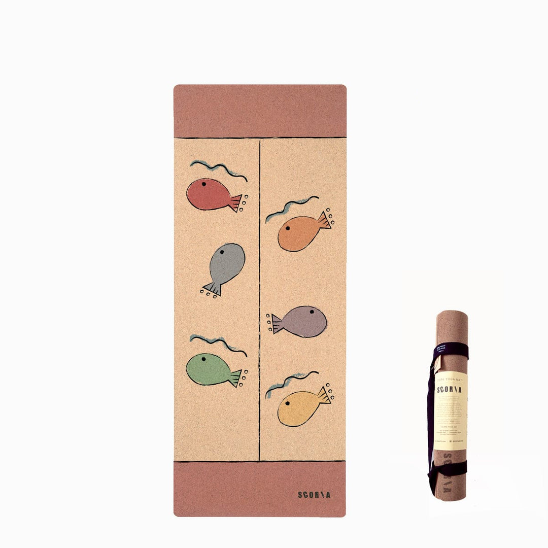 A yoga mat shown upright with its matching rolled sleeve beside it on a white background. The mat has a warm beige center with a dusty rose border at the top and bottom and simple fish illustrations in muted red, orange, gray, green, and yellow.