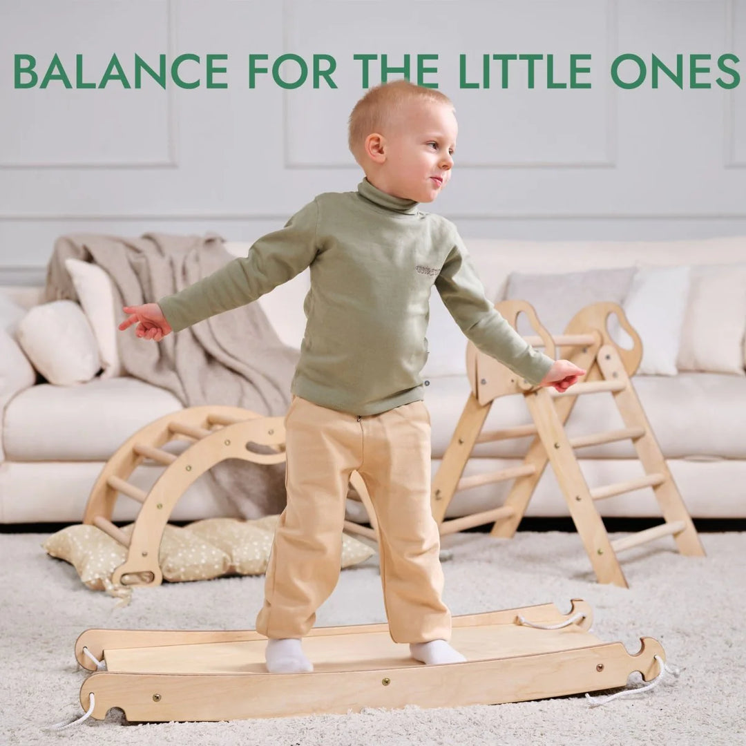 Child standing on a wooden balance board with text 'Balance for the Little Ones' above.
